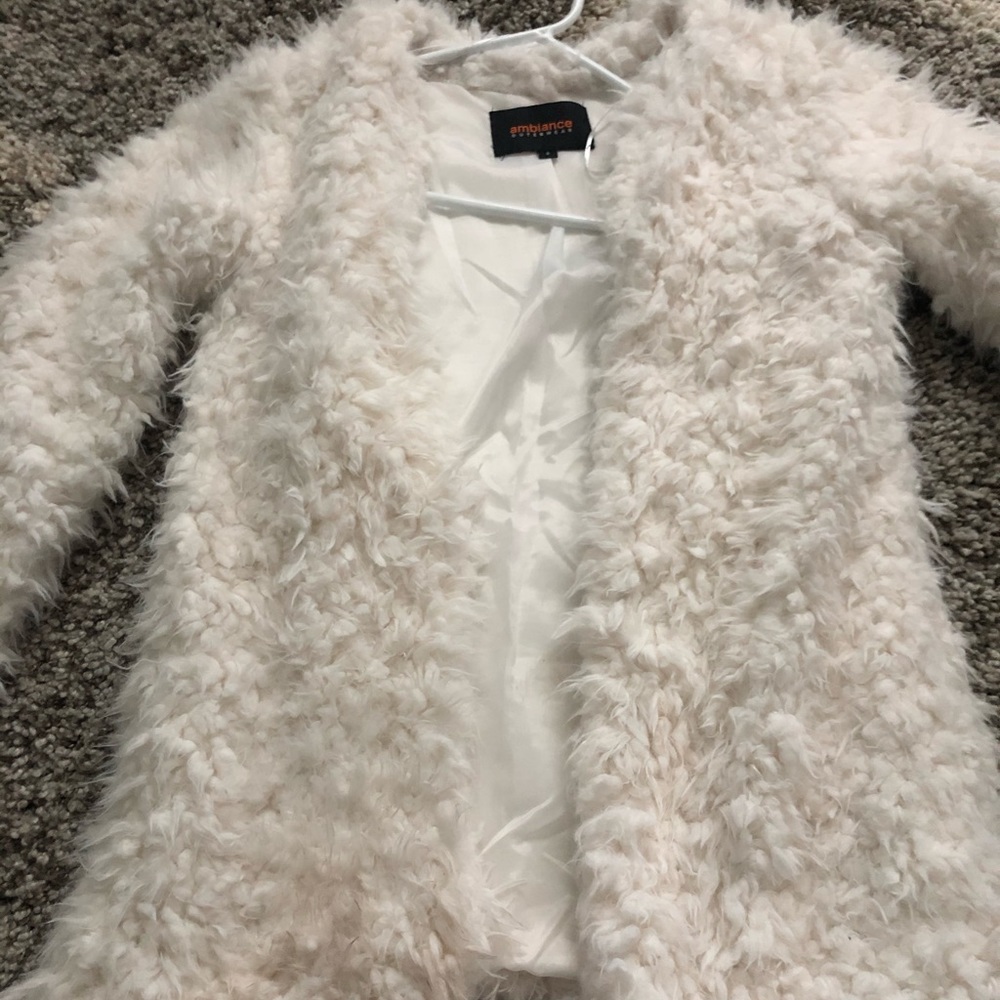 White fur coat/jacket.
